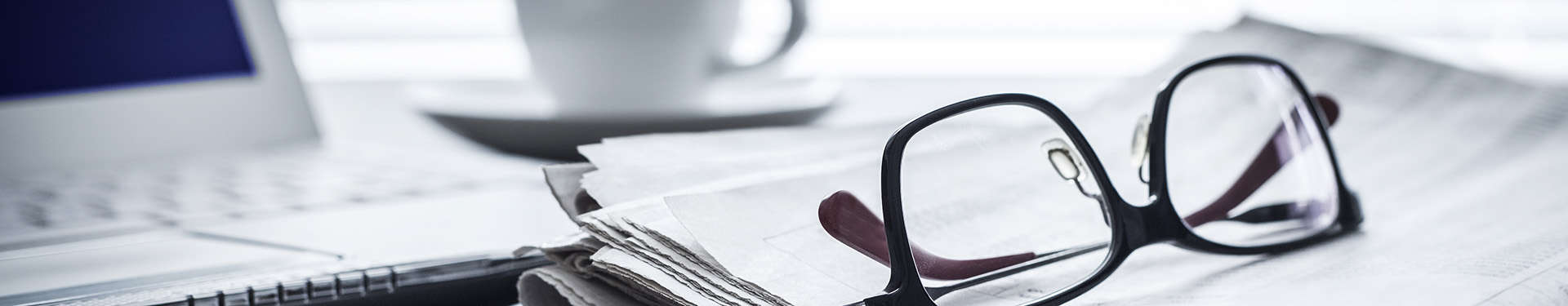 Newspaper with computer on table